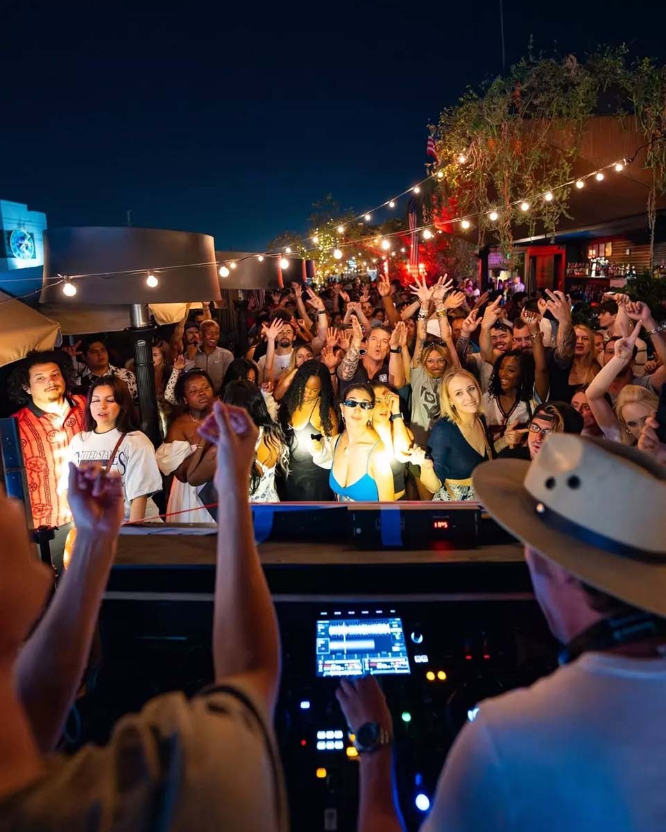 A crowd dancing at a rooftop party